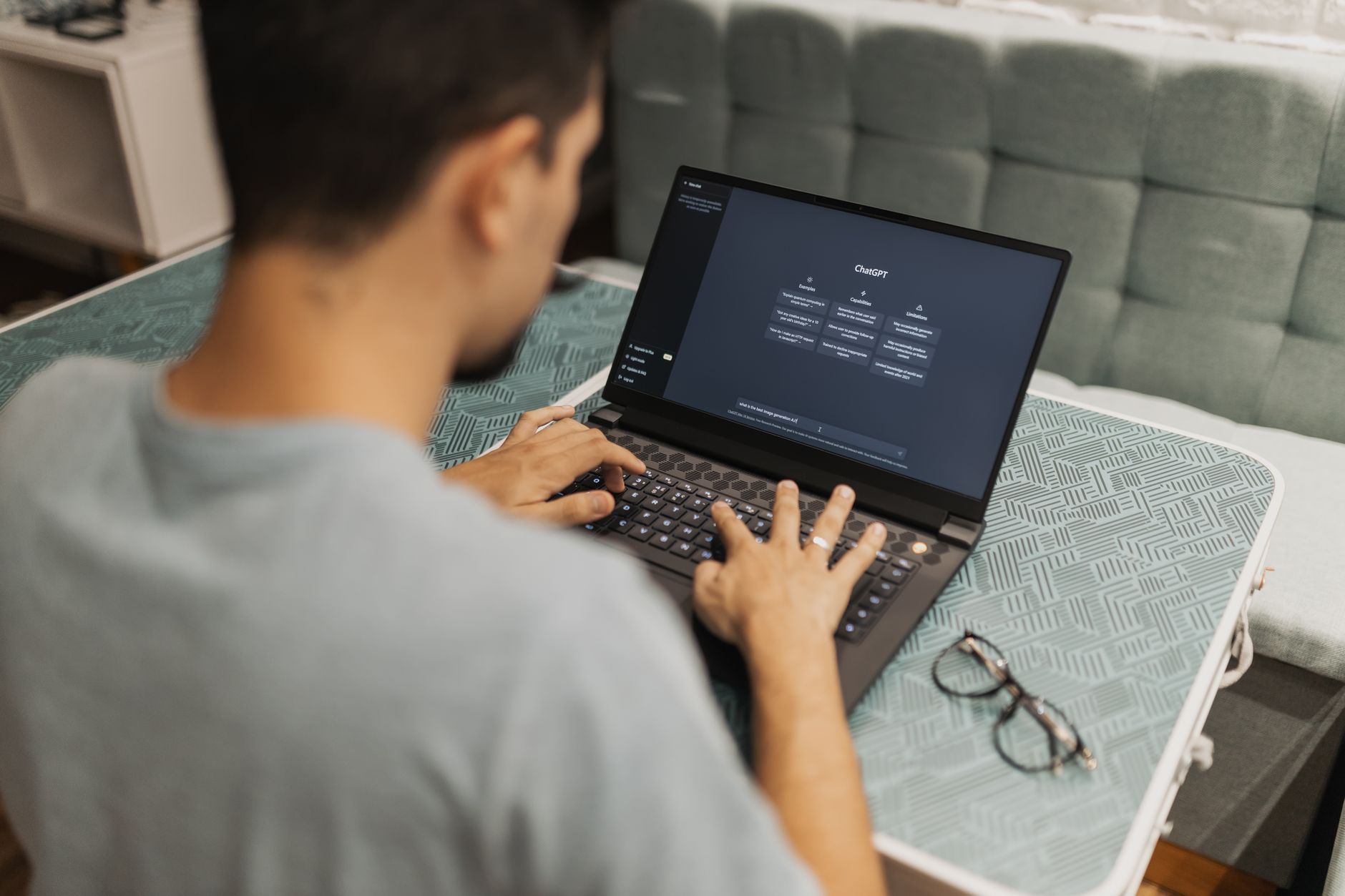 Person typing a prompt into ChatGPT on a laptop screen