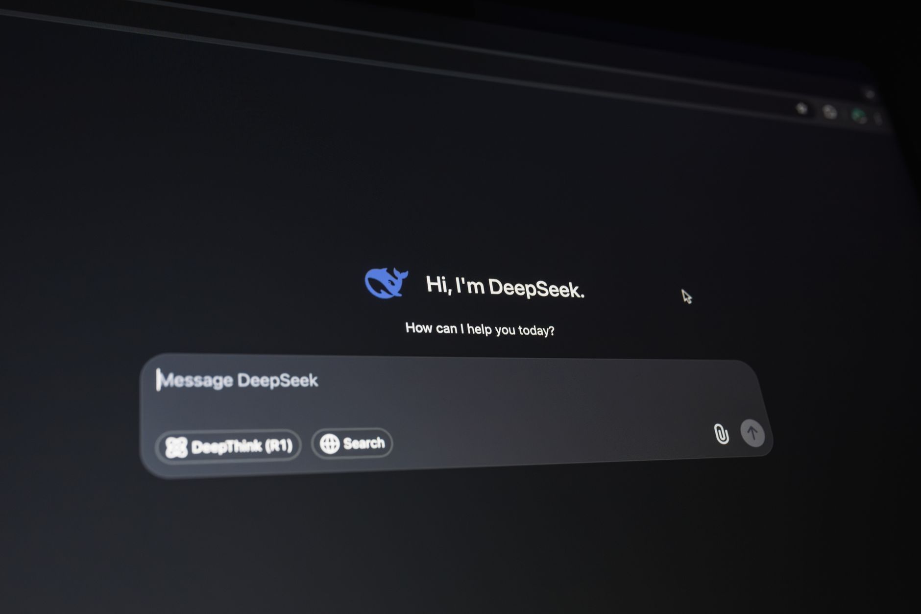 Person comparing two AI chatbot interfaces on a laptop screen side by side