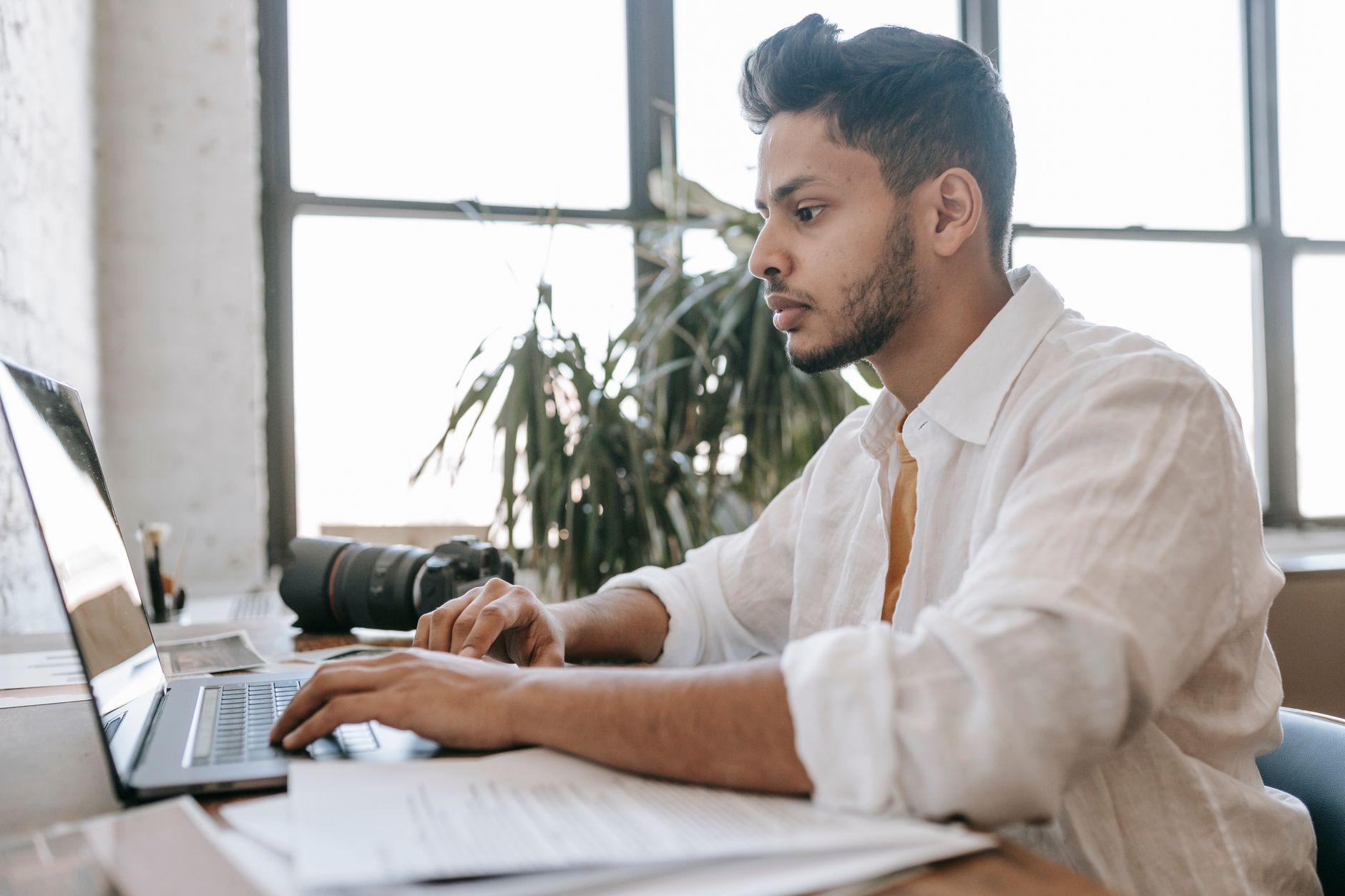 Job seeker comparing two resume versions on a laptop screen at a desk
